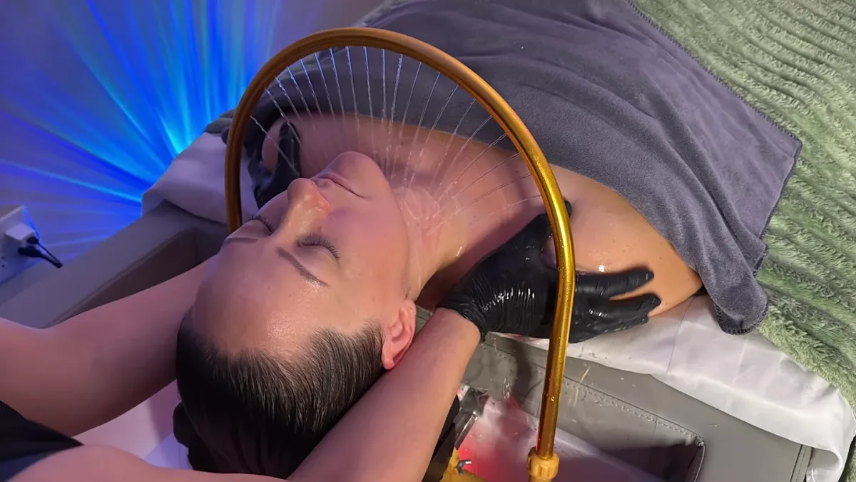 Warm-water rinse under the gold arch during a head spa session near Bothell