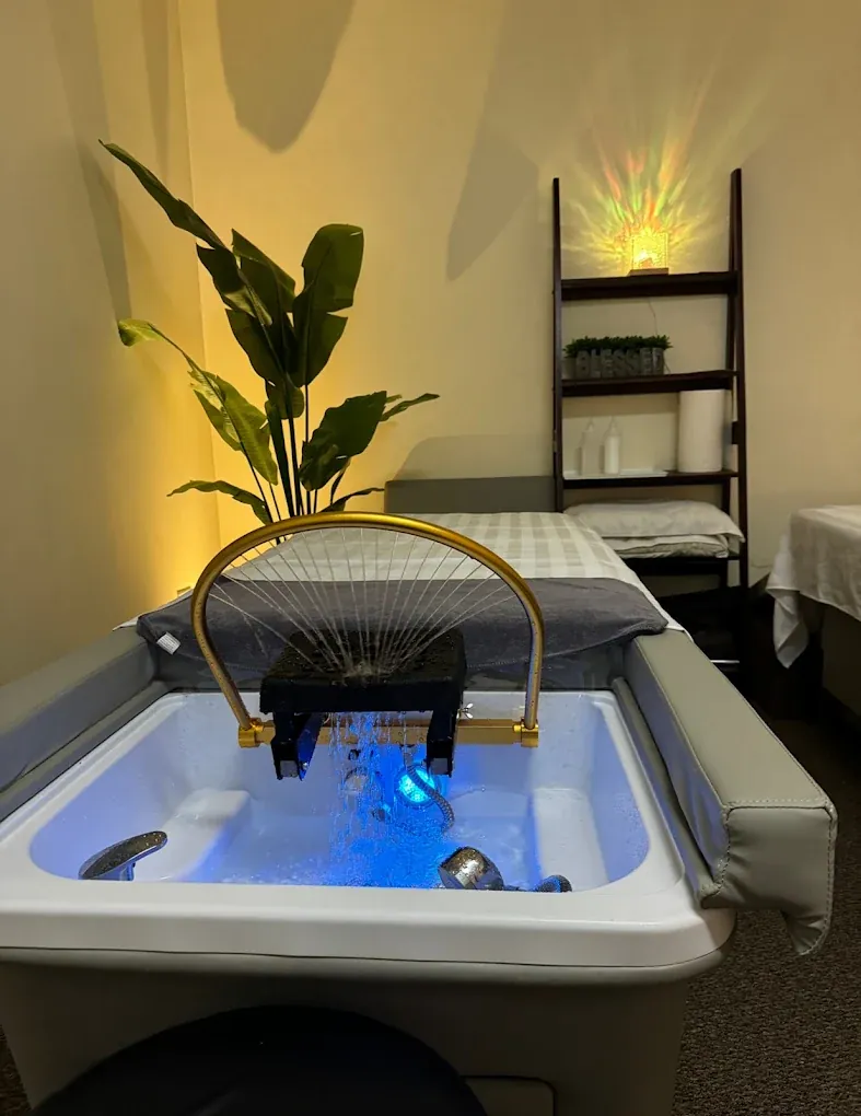 Head spa station with reclining rinse basin and warm lighting — Kirkland location