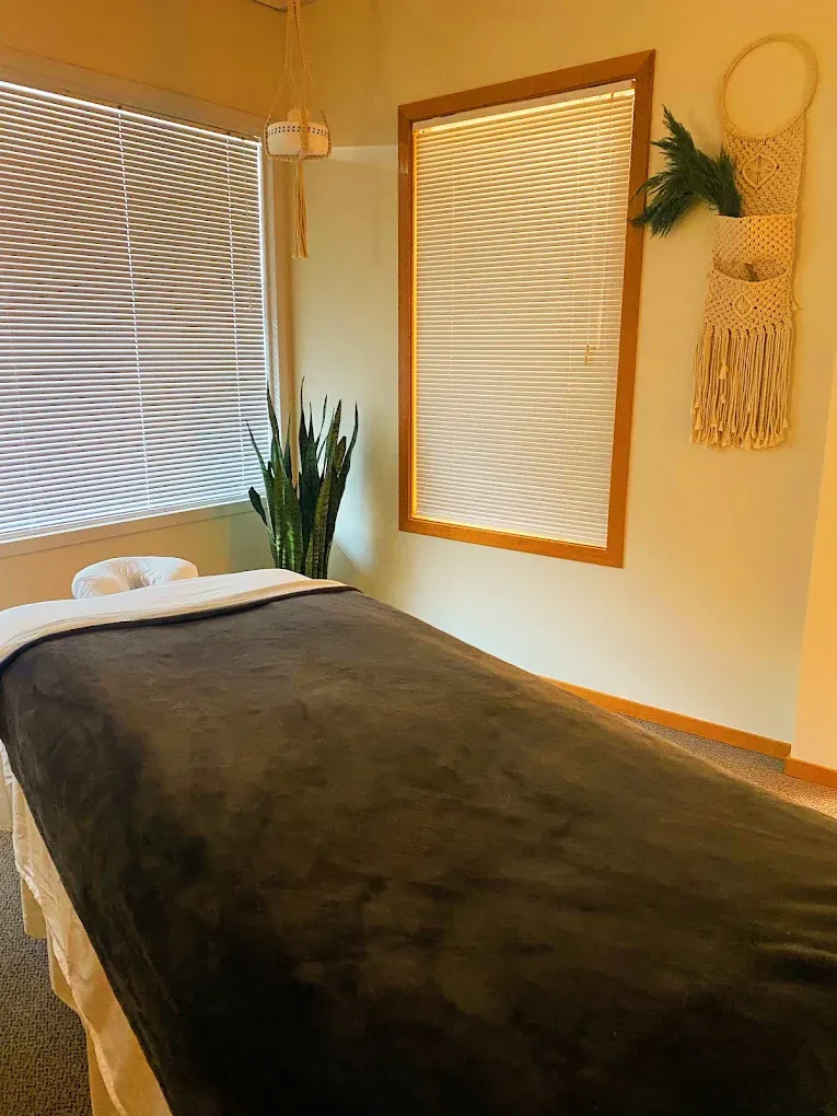 Private massage room with a prepared table and soft lighting — Everett location
